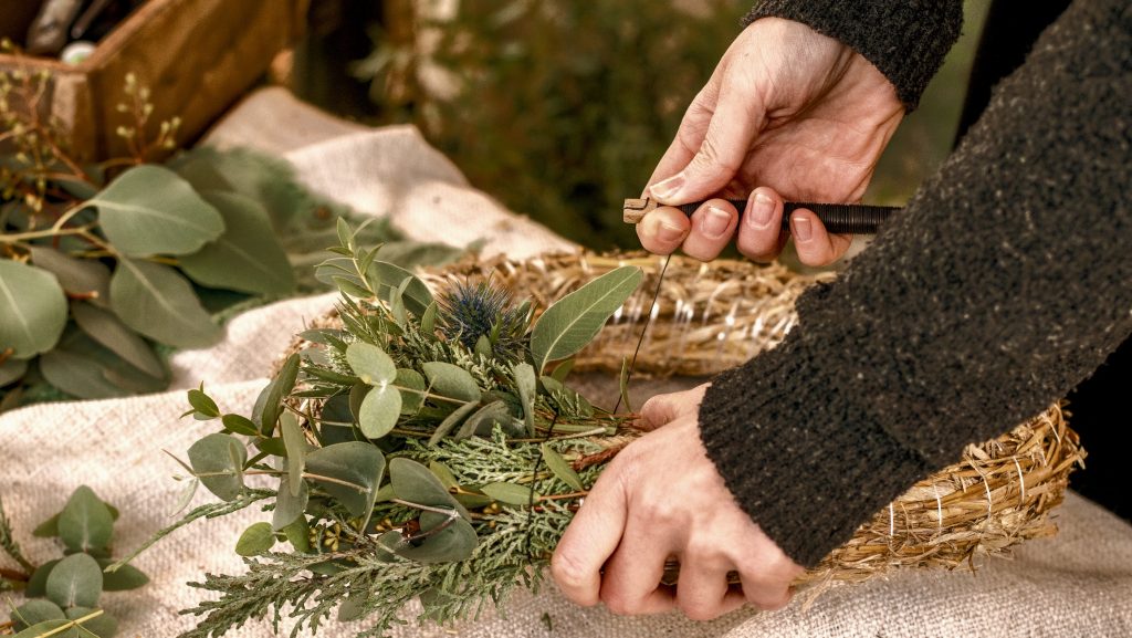 Tying a wreath with eucalyptus thistle mimosa and cypress make your own Advent wreath modern decoration for Christmas__edited